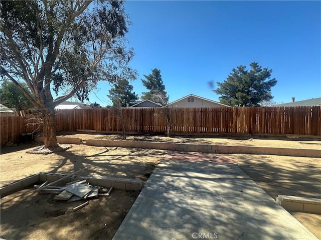 view of yard featuring a patio area and a fenced backyard