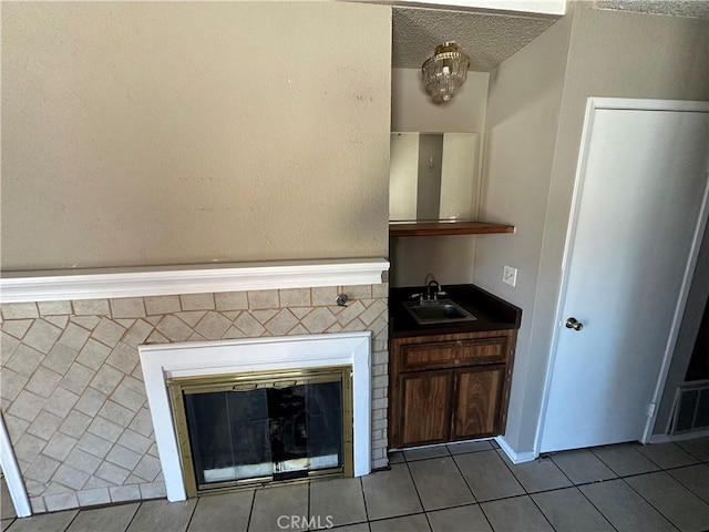 interior space featuring a fireplace, a sink, and visible vents