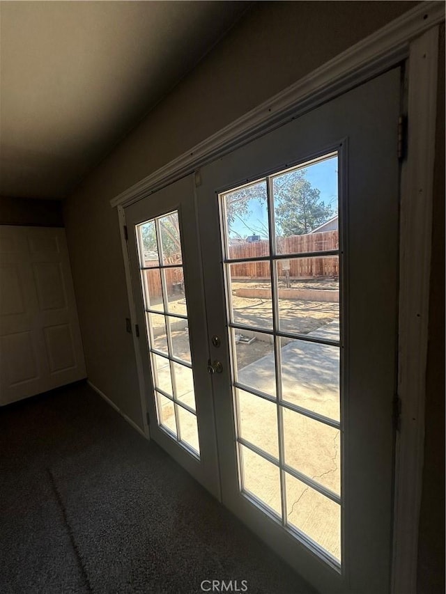 doorway with dark carpet and french doors