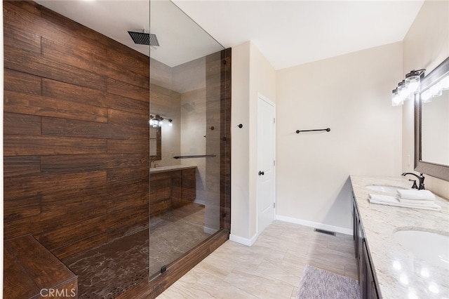 bathroom with vanity and tiled shower