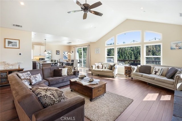 living room with high vaulted ceiling, dark wood-type flooring, and ceiling fan