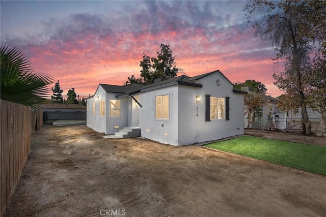 back house at dusk with a yard