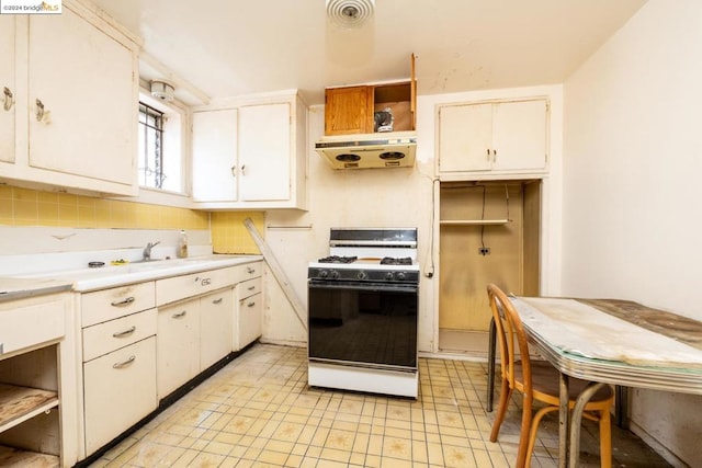 kitchen with white cabinetry, tasteful backsplash, gas range gas stove, and exhaust hood