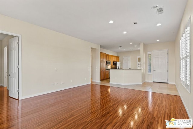 unfurnished living room featuring light wood-type flooring