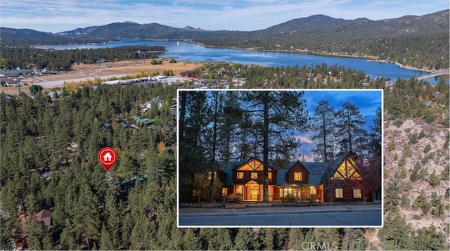 birds eye view of property with a water and mountain view