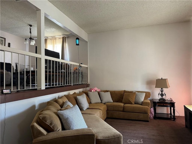 living room featuring beamed ceiling, carpet, a textured ceiling, and a notable chandelier