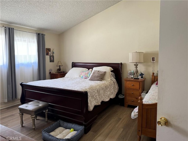 bedroom with hardwood / wood-style flooring and a textured ceiling