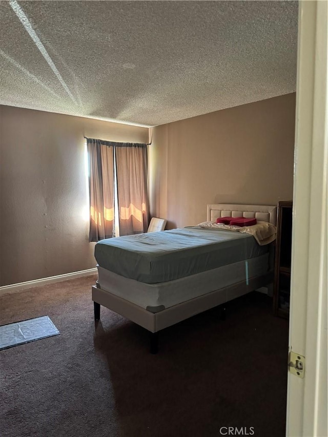 bedroom with dark colored carpet, a textured ceiling, and pool table