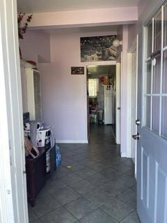 hallway with dark tile patterned flooring