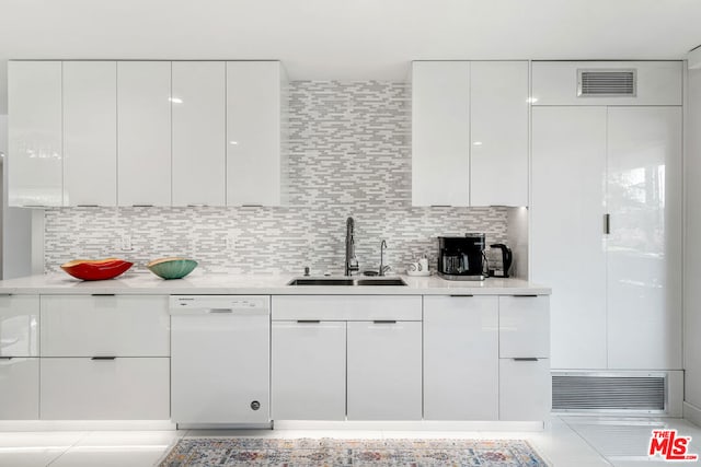 kitchen featuring sink, white cabinetry, dishwasher, and decorative backsplash