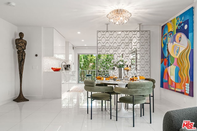 dining space featuring a chandelier, sink, and light tile patterned floors