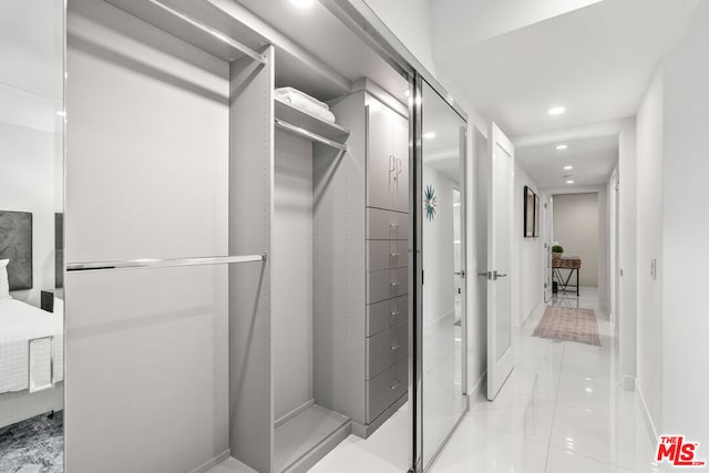 spacious closet featuring light tile patterned floors