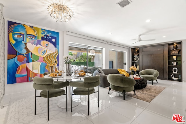 tiled dining room with ceiling fan with notable chandelier