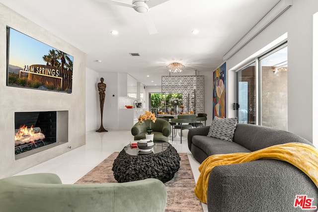 living room featuring light tile patterned flooring and ceiling fan