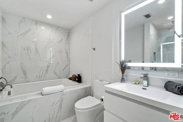 full bathroom featuring toilet, tiled shower / bath, and vanity