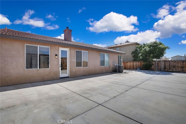 back of house featuring cooling unit and a patio area