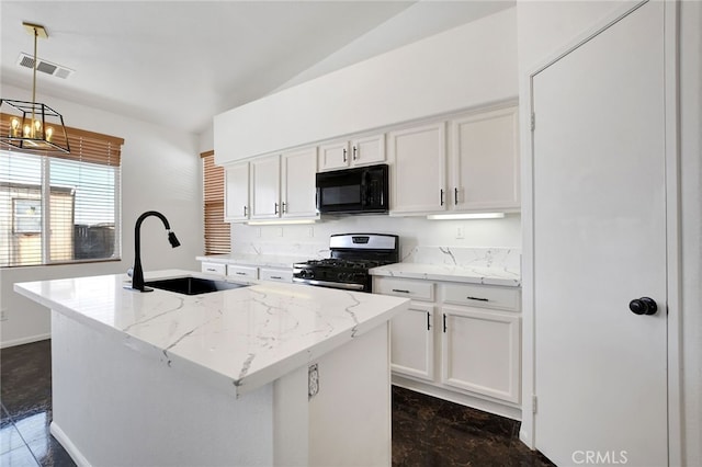 kitchen featuring a kitchen island with sink, sink, black appliances, pendant lighting, and white cabinets