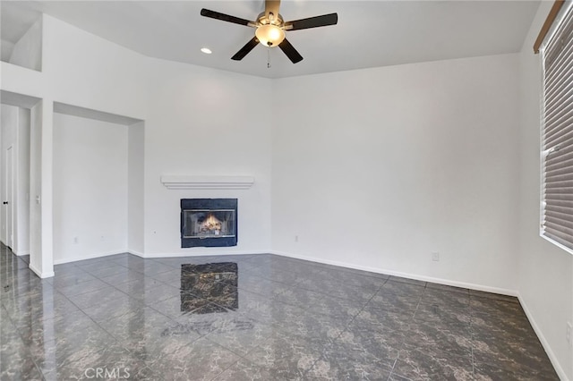 unfurnished living room with ceiling fan