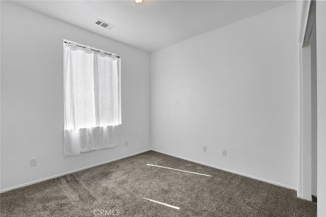 empty room with dark carpet