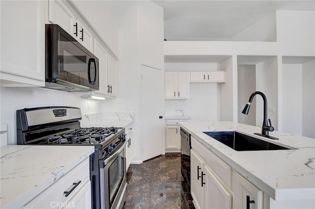 kitchen featuring light stone countertops, black appliances, sink, and white cabinets