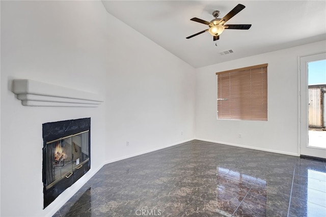 unfurnished living room with lofted ceiling, a high end fireplace, plenty of natural light, and ceiling fan