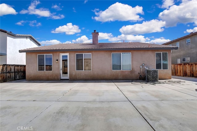 rear view of property with a patio area and central AC unit