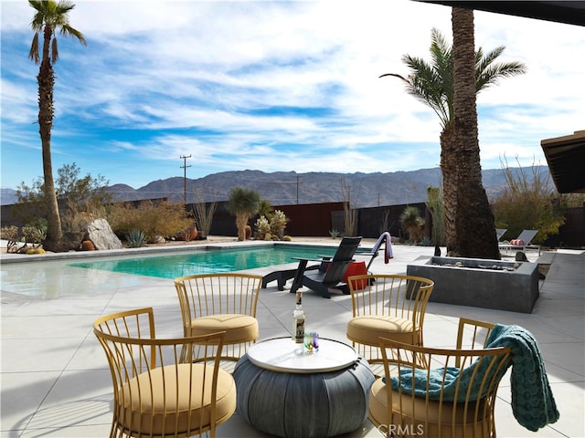 view of pool with a mountain view and a patio area