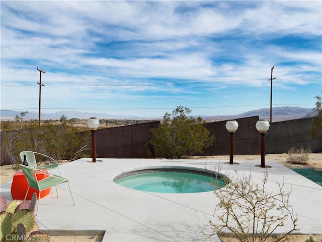 view of swimming pool with a patio area and an in ground hot tub