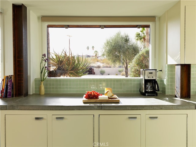 kitchen with decorative backsplash and a wealth of natural light