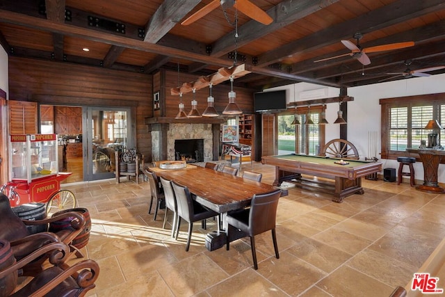 dining room with pool table, a premium fireplace, wood ceiling, and beamed ceiling