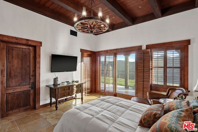 bedroom with beamed ceiling, a chandelier, wood ceiling, and a high ceiling