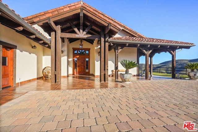 view of exterior entry featuring a mountain view