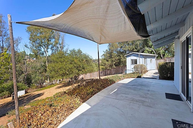 view of patio with a storage shed