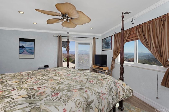 bedroom featuring wood-type flooring, ceiling fan, access to outside, and multiple windows