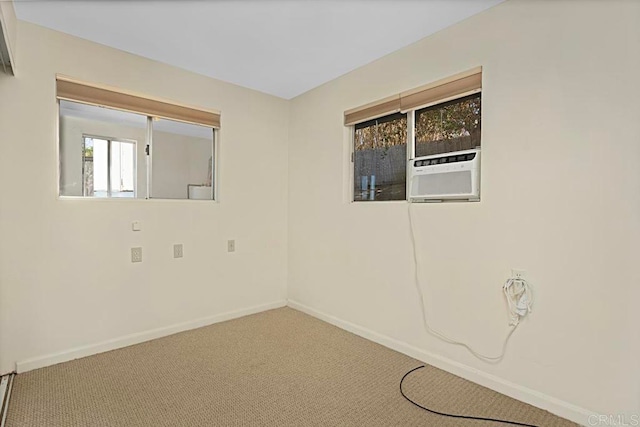 spare room featuring carpet and cooling unit