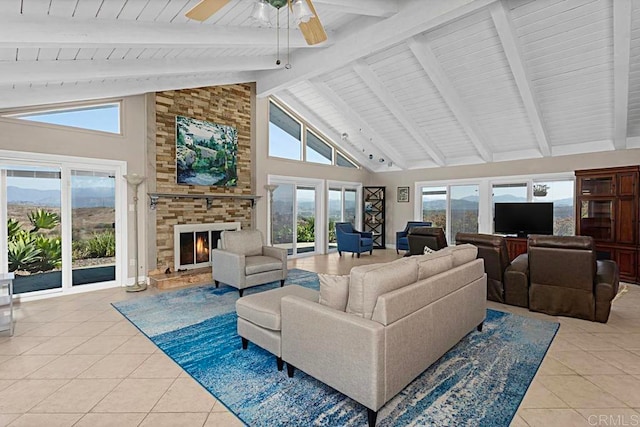 tiled living room with beam ceiling, high vaulted ceiling, and plenty of natural light