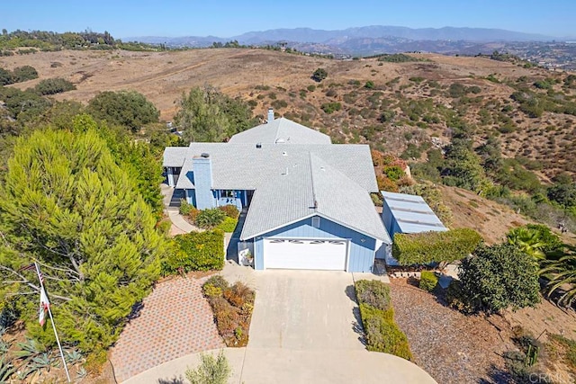 birds eye view of property featuring a mountain view