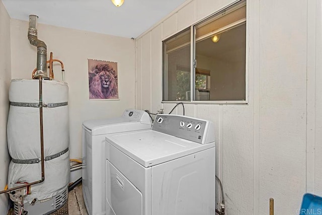 washroom featuring water heater and washing machine and clothes dryer