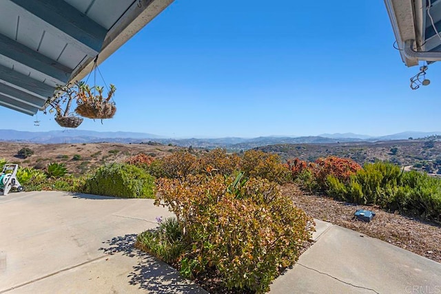 exterior space featuring a mountain view and a patio area