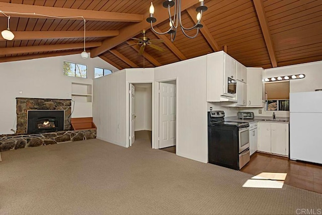 kitchen featuring a stone fireplace, kitchen peninsula, white cabinetry, white fridge, and stainless steel electric range oven