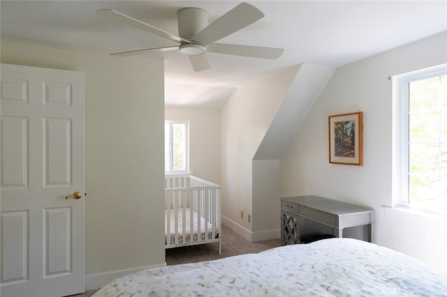 carpeted bedroom with vaulted ceiling and ceiling fan