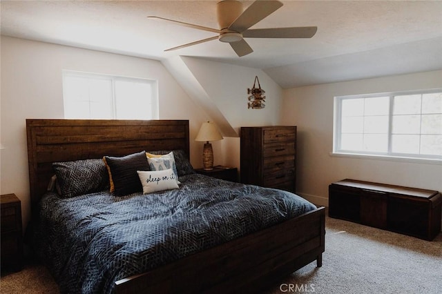 carpeted bedroom with ceiling fan and lofted ceiling