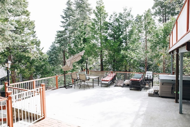 wooden deck with a patio area and a hot tub