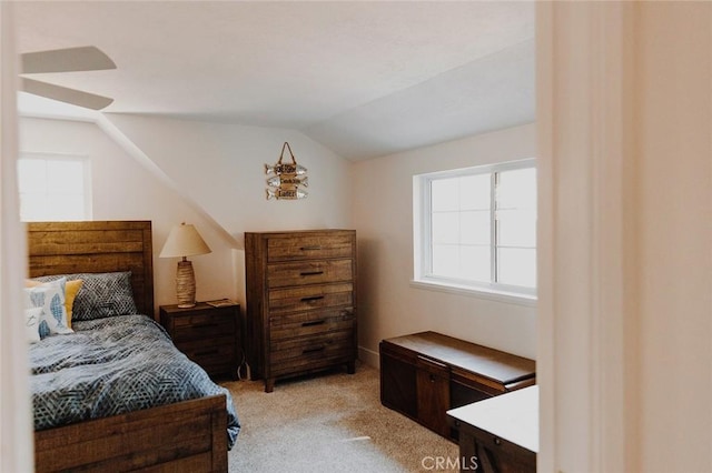 bedroom featuring light carpet and vaulted ceiling