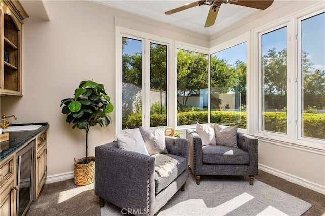 sunroom / solarium with ceiling fan and sink