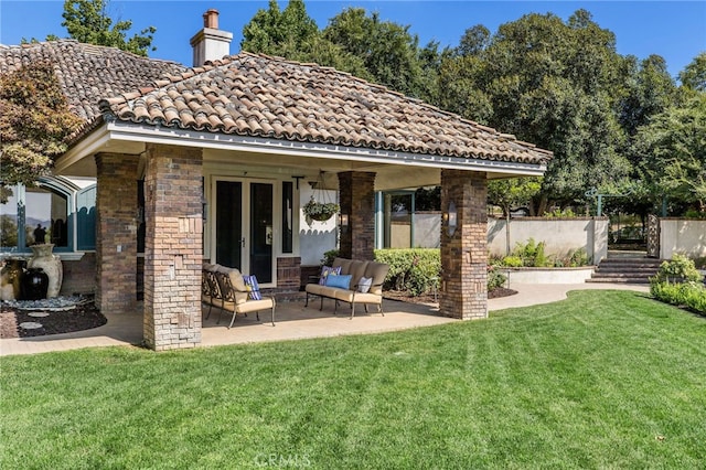 back of property with a patio and a yard