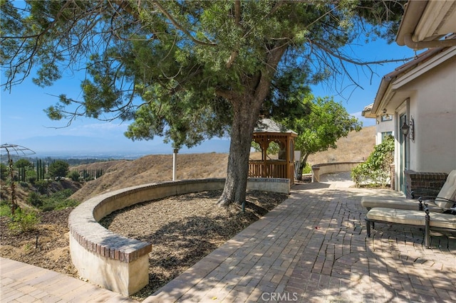 view of patio featuring a gazebo and a mountain view