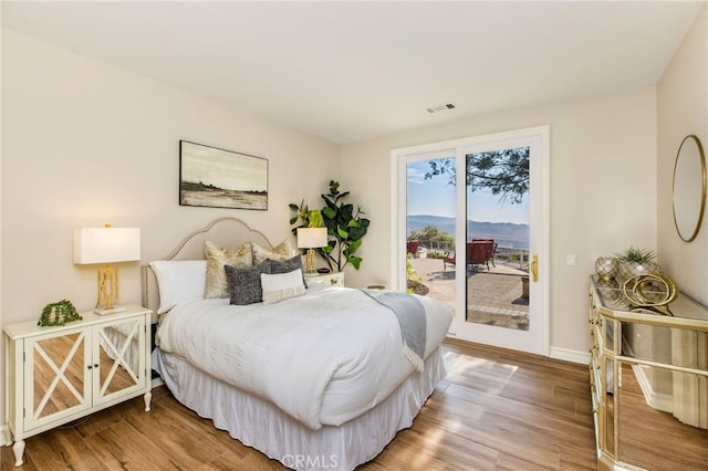 bedroom featuring access to outside and wood-type flooring