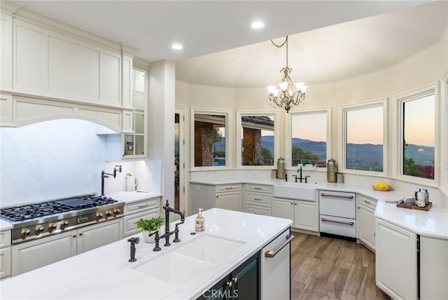 kitchen featuring backsplash, a healthy amount of sunlight, appliances with stainless steel finishes, and sink