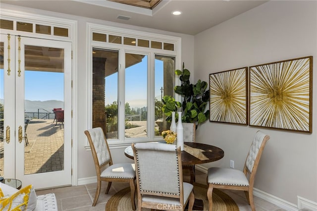 tiled dining area with french doors and a mountain view